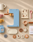 Flat lay of wooden pretend coffee maker playset with full accessories on beige background.
