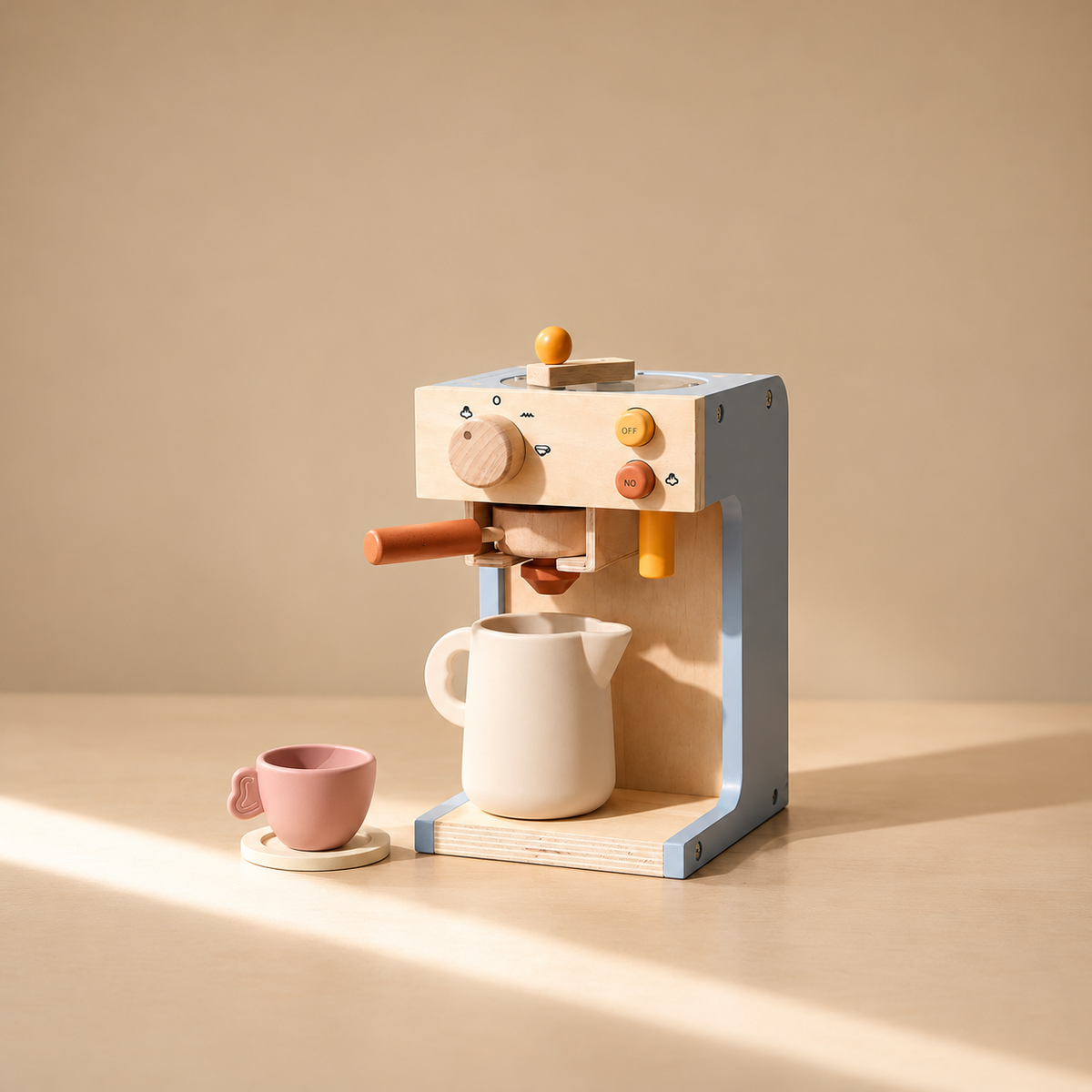 Wooden pretend play coffee machine with mug and pink cup on beige background.