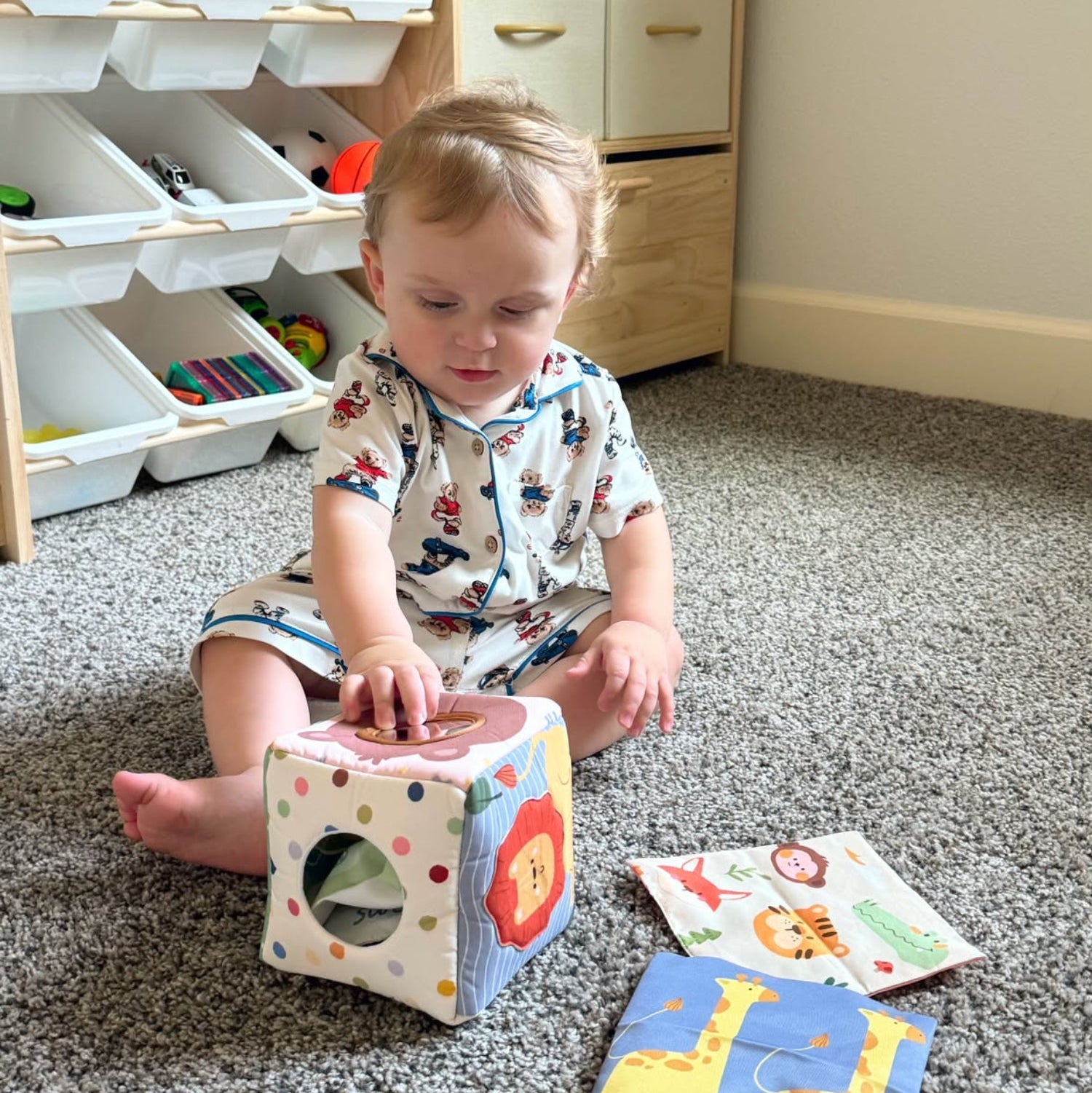 Baby playing with the LETSMAKE sensory tissue box toy and colorful fabric tissues.